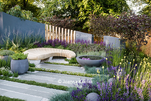 Healing Urban Garden; view of a modern patio with wooden bench and circular concrete water feature (pond),  amongst  Festuca glauca (blue fescue grass) Thymes, Lavandula, Nepeta. - Designer: Rae Wilki