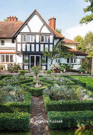 Brick path leading to the house amongst Buxus sempervirens topiary - formal box edged beds in front of the main house.