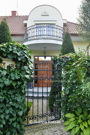 Entrance with black iron gate.