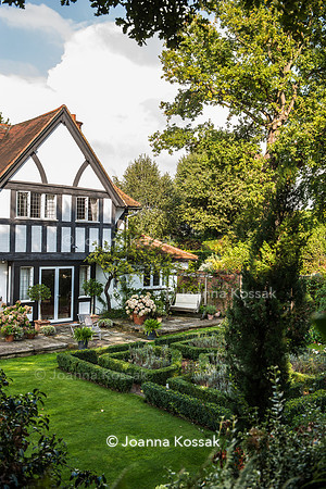 View of the garden with formal box (Buxus sempervirens) edged beds from the upper level of the garden.